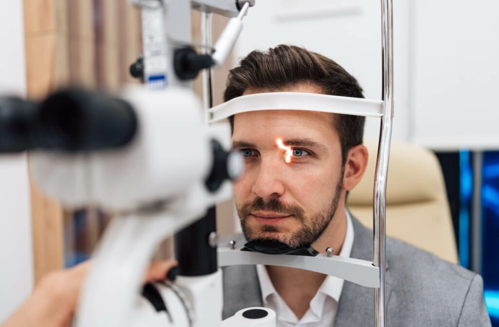 Patient undergoing a comprehensive eye exam with a laser light directed into the eye.